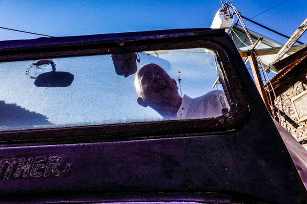 Namibian desert December 1, 2018 Silhouette of a man in an old jeep