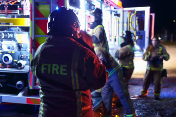 Firefighters taking equipment from fire truck and preparing