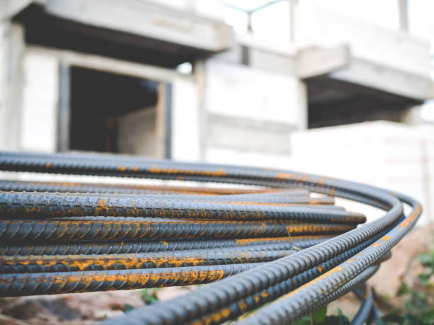 istock Stack of steel rebar for reinforcement concrete with house under construction 1078395672