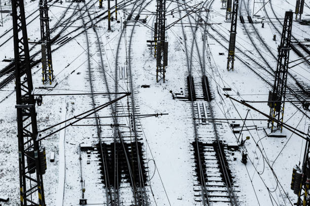 рельсовые пути, пересекающиеся в снегу - railroad track direction choice transportation стоковые фото и изображения