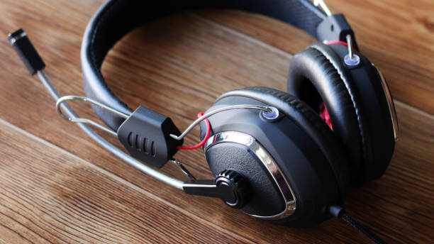 istock Headphones on wooden background 1078407706