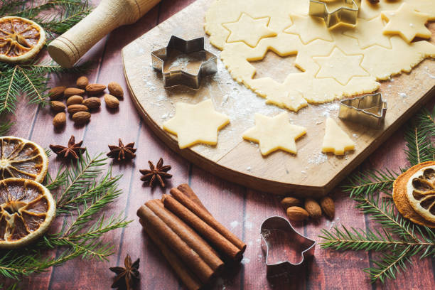 istock Ingredients for making Christmas cookies. Rolling pin cookie cutters cinnamon flour eggs butter dough on light background with copy space. 1078409450