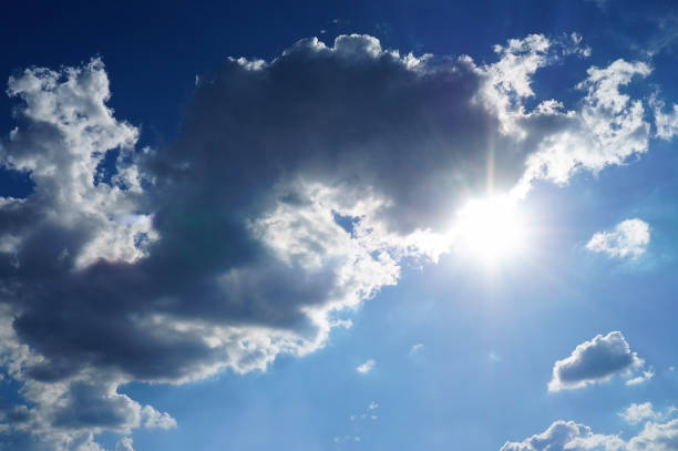 istock Blue sky after rain with white dark colored fluffy clouds. Background texture. 1078410952