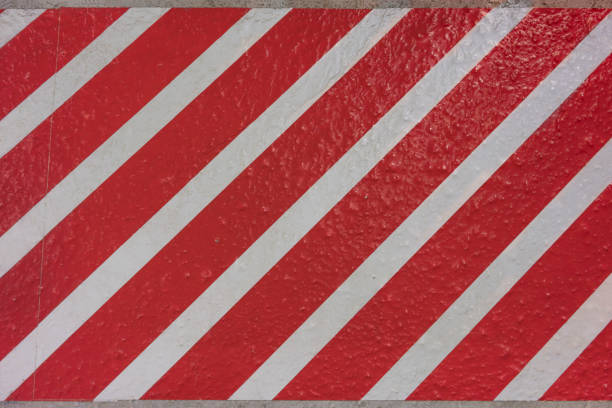 istock Sticker texture with red and white stripes diagonally on a concrete surface. 1078413018