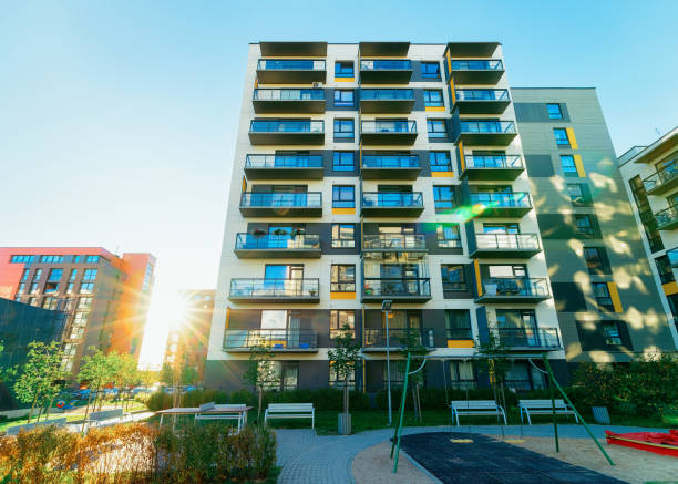 istock Apartment house buildings complex concept playground sun light 1078414504