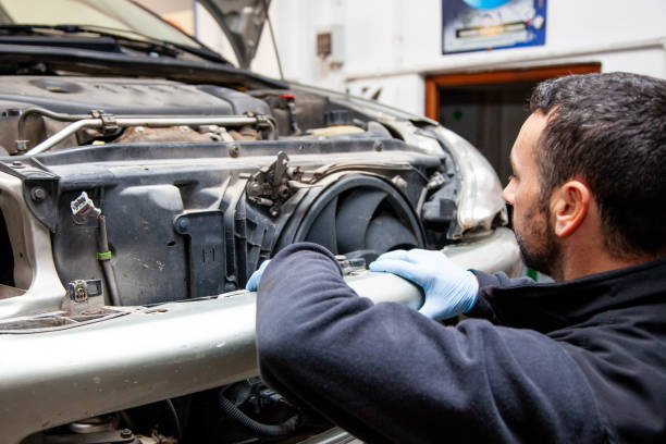 istock Mechanic repairs cars in his workshop using various tools 1078421686