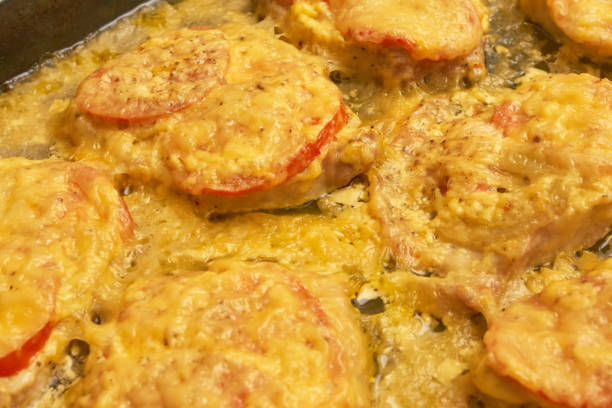 istock Baked meat with tomatoes and cheese, background texture close up 1078421954