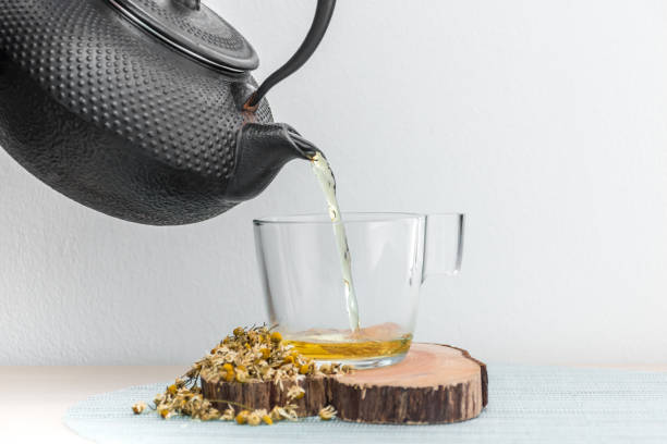 istock Pouring Chamomile Tea  from the Tea Kettle 1078423942