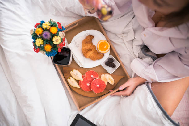 istock Woman Having Breakfast On Bed At Home 1078424386