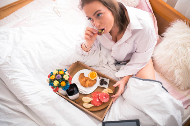 istock Woman Having Breakfast On Bed At Home 1078424480