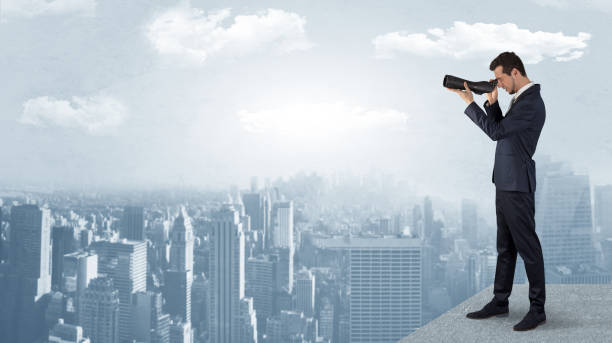istock Man looking forward from the top of a skyscraper 1078425012