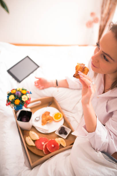 istock Beautiful young woman having breakfast 1078425174