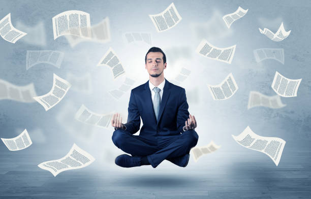 istock Businessman meditating with flying paper concept 1078427242