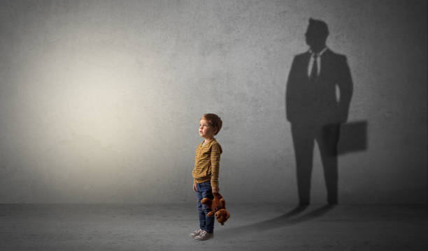 istock Little boy with businessman shadow 1078427364