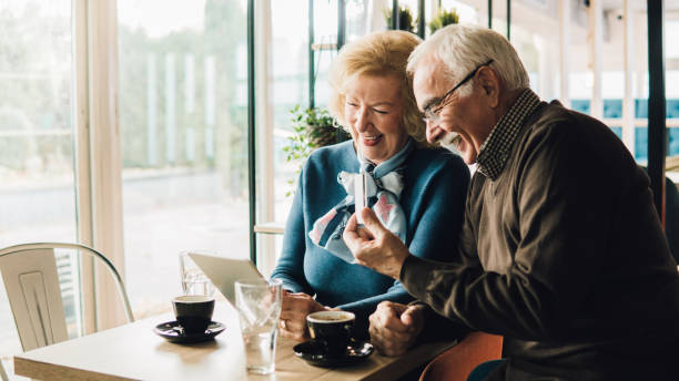 istock Old couple holding credit card and digital tablet 1078427616