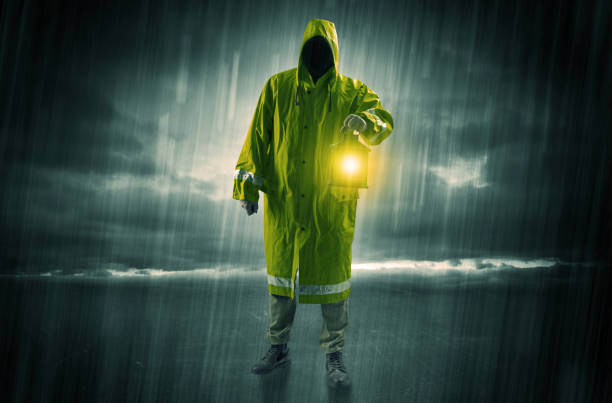 istock Man walking in storm with lantern 1078428000