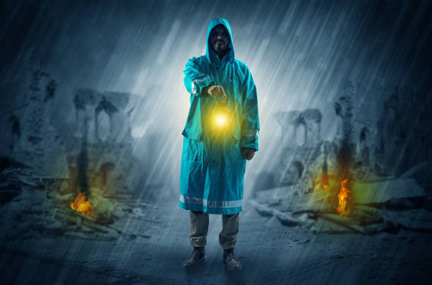 istock Man with a glowing lantern at a catastrophe scene 1078428516