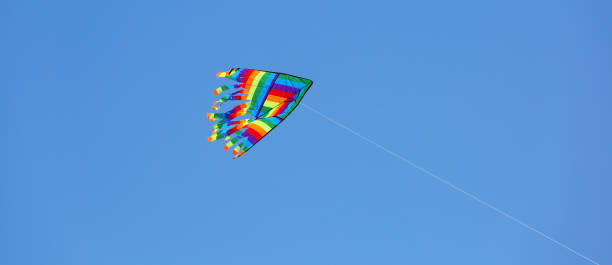 istock colored kite flies in the blue sky 1078429810