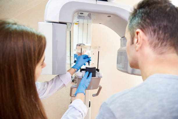 istock doctor and patient next to x-ray machine 1078432676