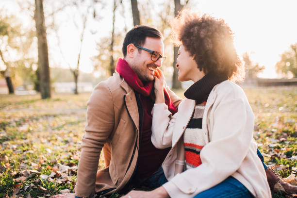 istock Young couple sitting in the park 1078432862