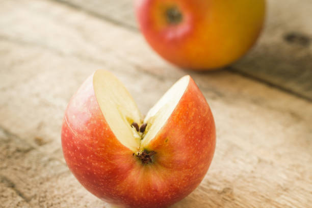 istock Sweet cut red apple on a wooden table 1078432888