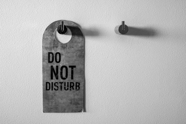 istock Do not disturb sign on the white wall 1078433700