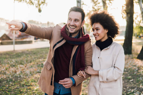 istock Happy young couple walking in the park 1078434066