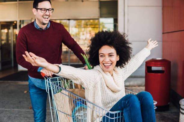 istock Couple having fun with shopping cart 1078438098