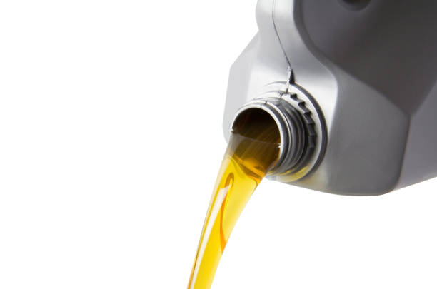 istock pouring motor oil from silver plastic gallon bottle isolate on white background, yellow hydrocarbon petroleum liquid in grey canister. 1078443666