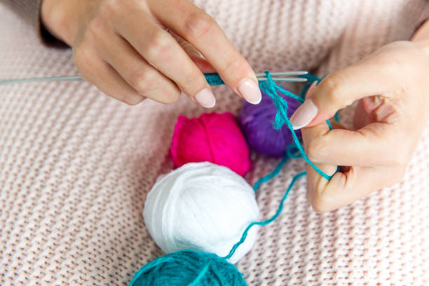 istock Female hands knitting with wool, top view 1078447082