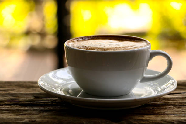 istock Hot cofffee cup on wooden with painting leaf 1078448596