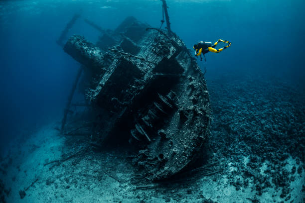 istock Yellow suited scuba diver exploring a shipwreck under the Red Sea 1078449414