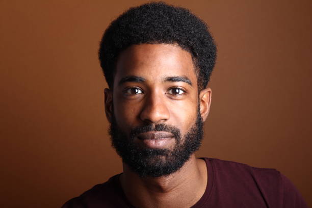 istock Beautiful black man in front of a brown background 1078454514
