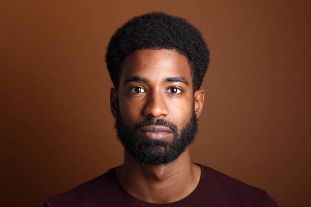 Beautiful black man in front of a brown background