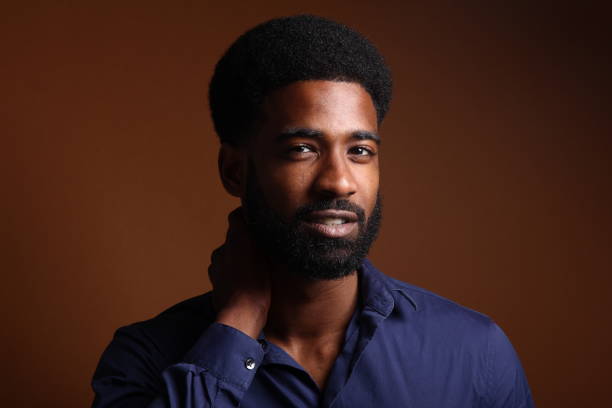 istock Beautiful black man in front of a brown background 1078456018