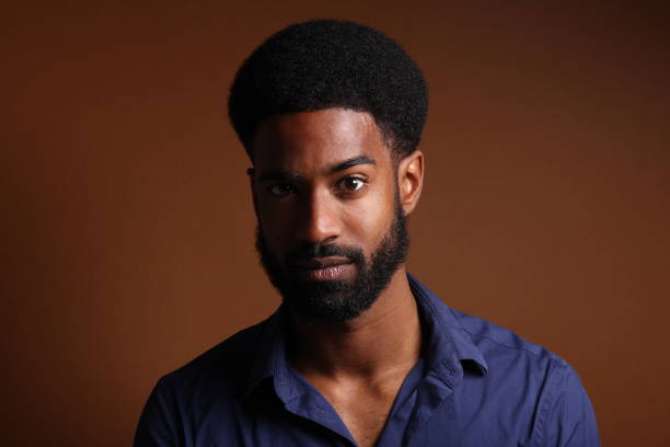 istock Beautiful black man in front of a brown background 1078456028