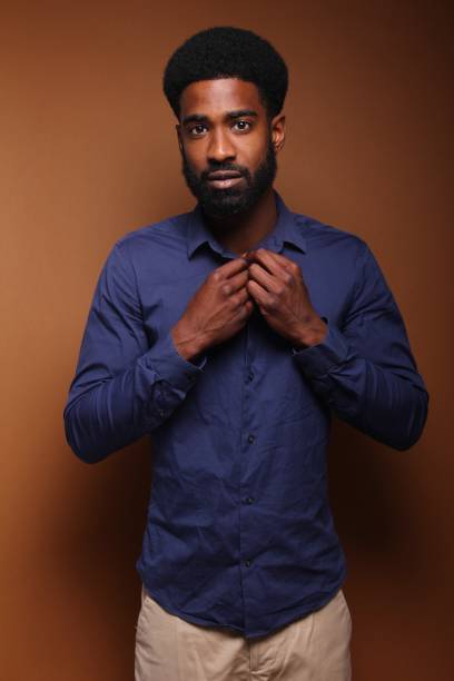 istock Beautiful black man in front of a brown background 1078456470