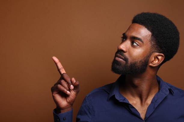 istock Beautiful black man in front of a brown background 1078456478