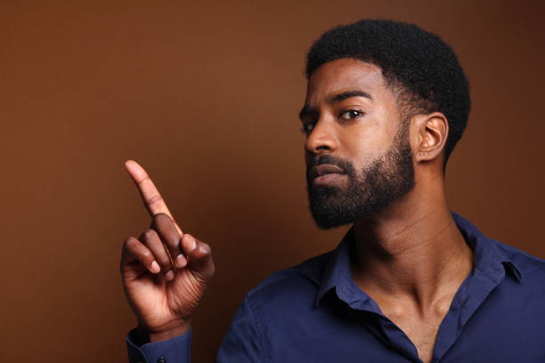 istock Beautiful black man in front of a brown background 1078456482