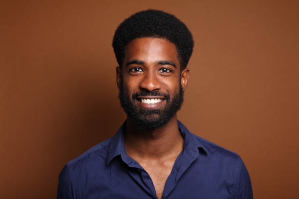 istock Beautiful black man in front of a brown background 1078456484
