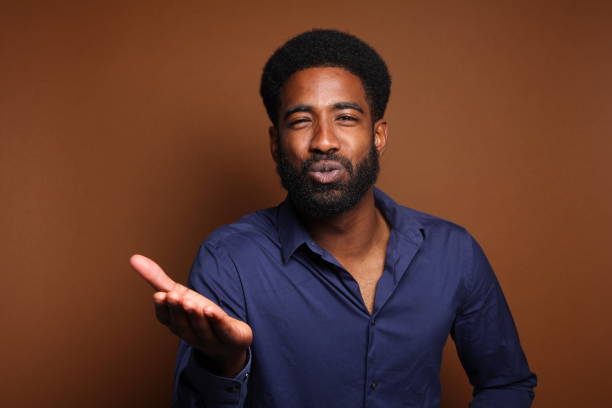 istock Beautiful black man in front of a brown background 1078456486