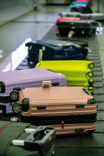 Vertical photo of many colorful suitcase and luggage in line at airport stock photo