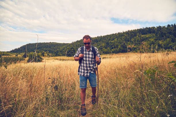 istock Hiker enjoying nice view in a hilly landscape. 1078463578