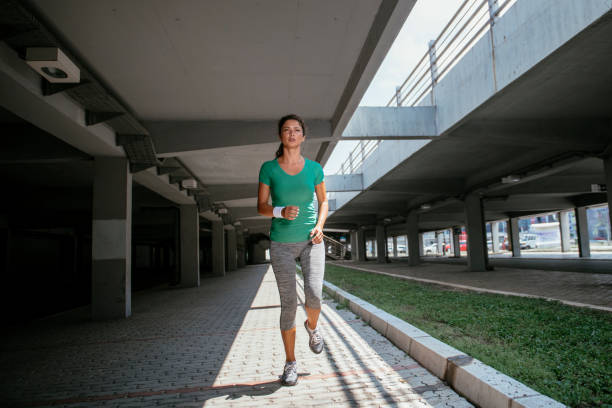 istock Young woman running outdoors 1078463634