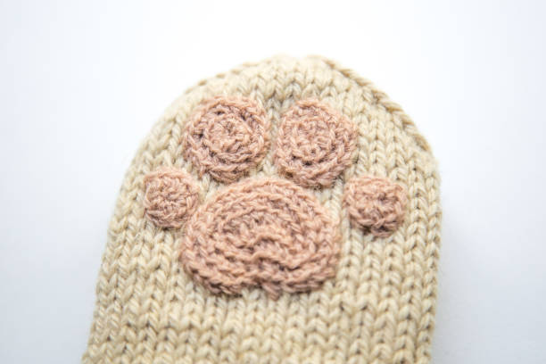 istock A beautiful closeup od a knitted wool socks with a crocheted animal paw pattern. 1078469526