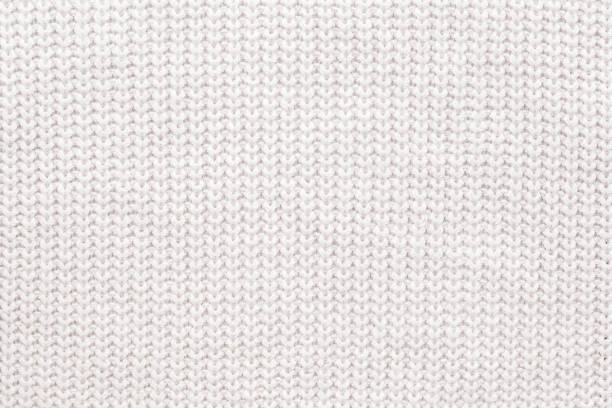 istock Abstract knitted background. White woolen sweater texture. Close up picture of  knitted pattern. 1078473672