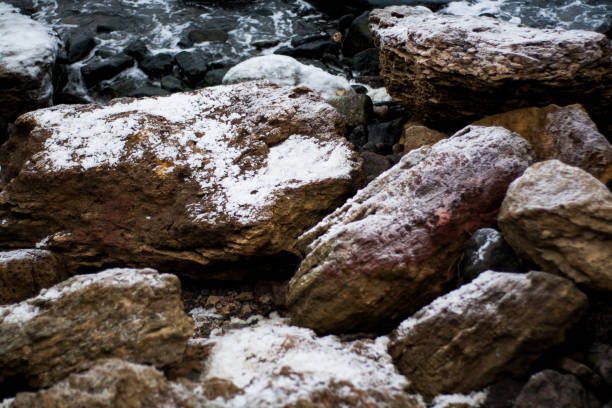 istock Sea waves break on frozen stones 1078474956