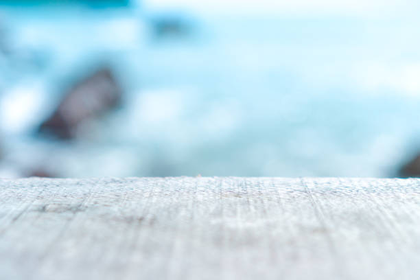 istock Selective focus of old wood table with blur beautiful beach background for display your product. 1078477978
