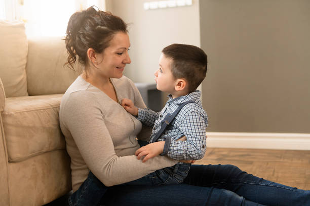 istock mother with boy sitting on couch at home 1078479044