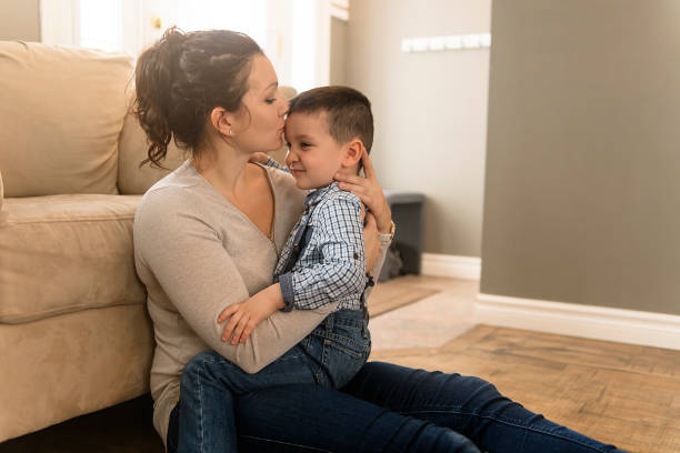 istock mother with boy sitting on couch at home 1078479068
